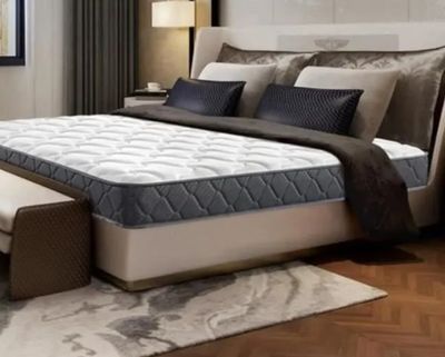 un lit sur lequel est posé un matelas dans une pièce