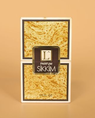 a close up of a box of perfume sitting on a table