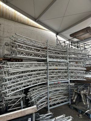 a large pile of metal pipes in a warehouse