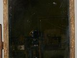 a mirror sitting on top of a wooden table