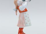 a figurine of a girl drinking from a vase