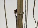 an antique brass table lamp with chains and chains hanging from it