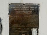 a metal sign on the side of a white wall