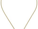 un collier en or avec un pendentif en forme de croix au bout d'une chaîne