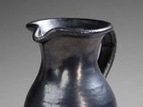 a black vase that is sitting on a table