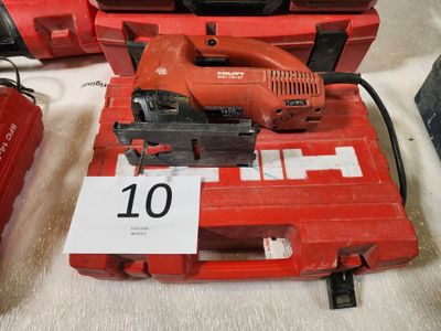 une image représentant une boîte à outils rouge sur laquelle est posée une scie filaire