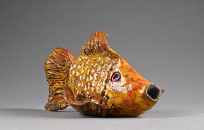 a small ceramic fish that is sitting on a table