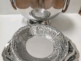 a silver bowl and a silver bowl on a white table