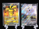 two pokemon cards are on display on a black background