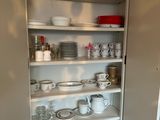 a cupboard with dishes and cups on it in the kitchen