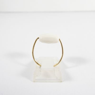 a close up of a gold ring with a white stone on it