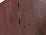 a close up of a wooden chair with holes in the back