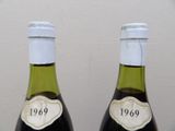 two bottles of wine that are sitting on a table