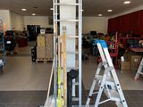 a picture of a room with a ladder and a ladder on the floor