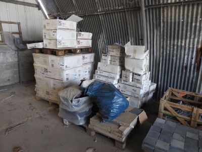a pile of boxes sitting on pallets in a warehouse