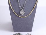 necklace and earring set on display in a display case