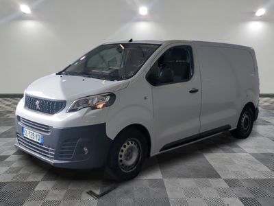 the white van is parked in a large room with a checkered floor