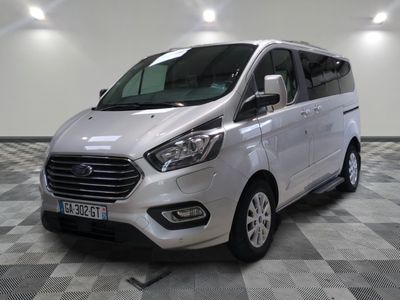 the white van is parked on a checkered floor in a room