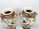 pair of chinese vases with asian scenes on them on a white background