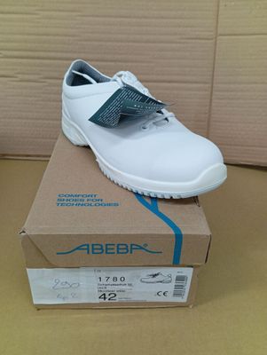 the shoe is white and has a blue ribbon on the side of it
