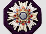 a purple velvet case with a gold and blue broochle