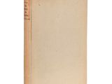 a book with a brown cover sitting on top of a white surface