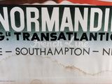 a sign on the wall that says normandie c c et transalintique
