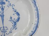 a blue and white plate with a design on it
