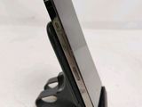 a close up of a cell phone on a stand on a table