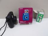 a blue camera and headphones on a white table