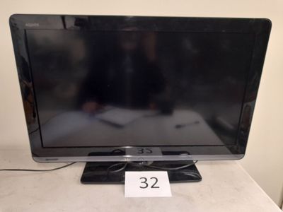 a television that is sitting on a table with a price tag in front of it