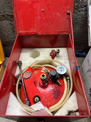 a red box with a hose in it and a hose in it