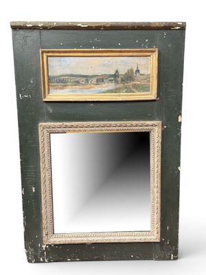 an old wooden mirror with a painting hanging on it ' s side