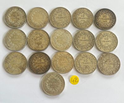 a bunch of coins sitting on top of a table next to a yellow coin