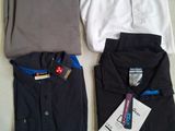 three men ' s shirts and a woman ' s shirt on a table