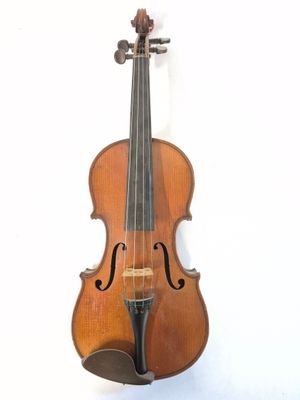 a close up of a violin sitting on a white surface