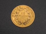 a close up of a gold coin on a black surface