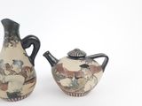 two vases that are sitting side by side on a white surface