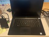 a laptop computer sitting on top of a white desk