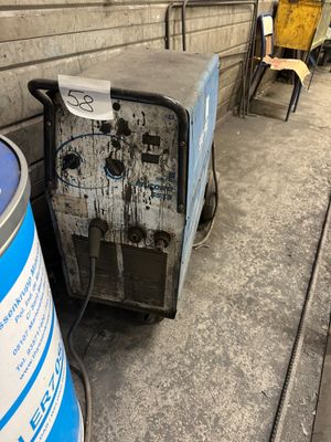 a trash can sitting next to a trash can on the side of the street