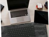 a laptop computer sitting on a desk with a mouse and keyboard