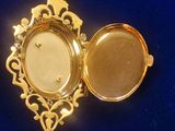 a gold locke with a picture in it on a blue surface
