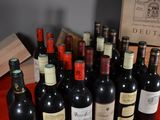 many bottles of wine sitting on a red table cloth
