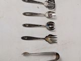 several forks and spoons are arranged in a row on a table