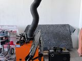 a man standing next to a machine that has a hose attached to it