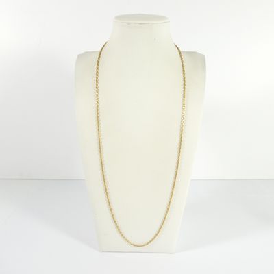 a white mannequin torso with a gold chain on it