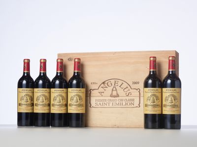 six bottles of red wine in a wooden box on a table