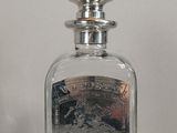 a bottle of perfume sitting on a white surface
