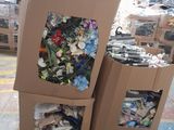 two boxes of garbage sitting on a pallet in a warehouse