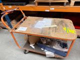 a cart with a wooden table on it in a store